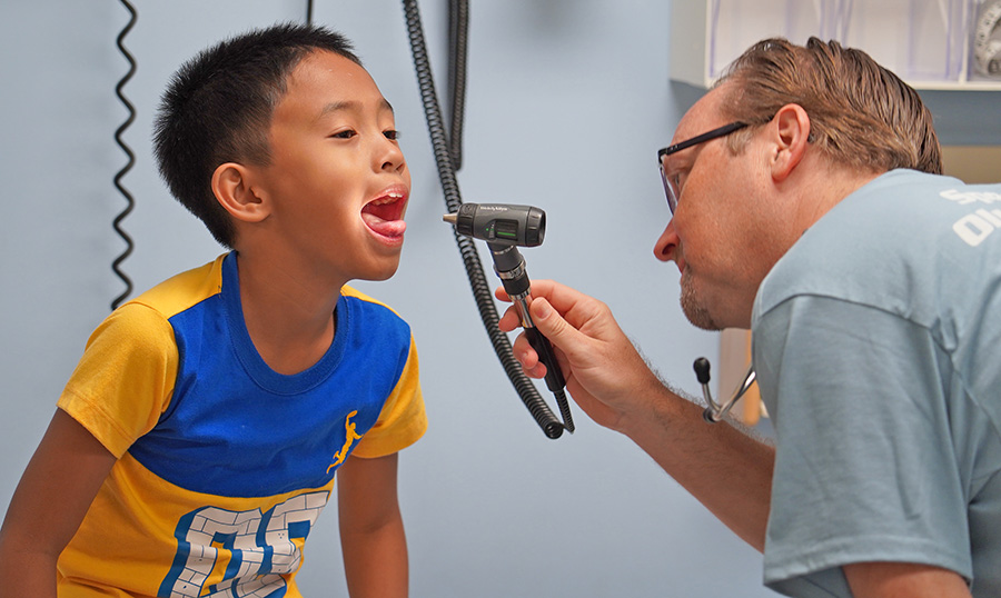 boy being examined by a physician